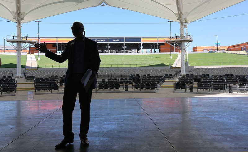 The new Choctaw Plaza is visible behind Peter Lane, president and chief executive officer of the Walton Arts Center, as he leads a tour Thursday, August 20, 2020, of the newly expanded Walmart Arkansas Music Pavilion in Rogers. The venue completed a $17.2 million expansion that includes a covered plaza at the top of the lawn, more concession stands, additional restrooms, an expanded main entry plaza and backstage amenities for artists such as new dressing rooms. Check out nwaonline.com/200821Daily/ and nwadg.com/photos for a photo gallery.
(NWA Democrat-Gazette/David Gottschalk)