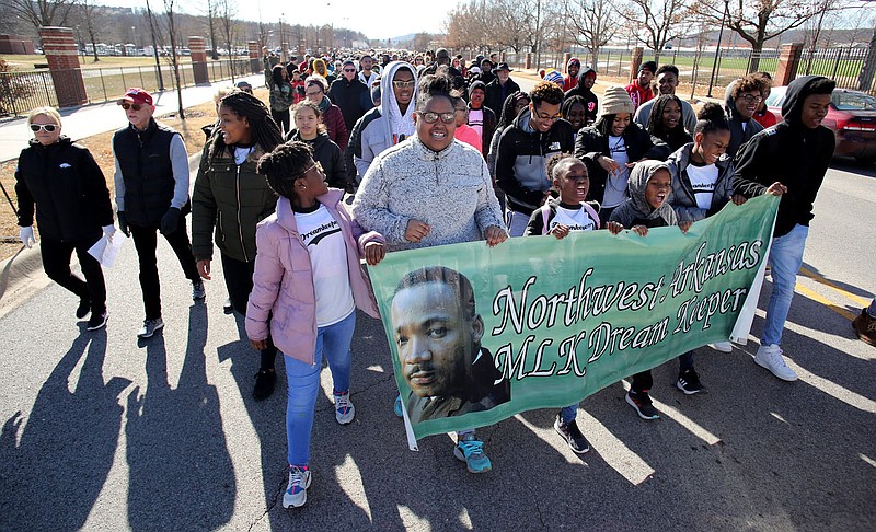 NWA Democrat-Gazette/DAVID GOTTSCHALK Members of the Northwest Arkansas Dream Keepers and friends carry a banner Monday, January 21, 2019, in the annual Martin Luther King Jr. Freedom March to the campus of the University of Arkansas in Fayetteville. Participants in the march, sponsored by the Northwest Arkansas Martin Luther King, Jr. Council, began near the corner of Razorback Road and Martin Luther King, Jr. Boulevard and marched, sang and chanted to the Arkansas Union for the Dr. Martin Luther King, Jr. Vigil presented by the University of Arkansas Associated Black Student Association with the Associated Student Government. The keynote speaker was Angela Mosley Monts, assistant vice chancellor for Diversity and Inclusion in the Office for Diversity and Inclusion at the university.