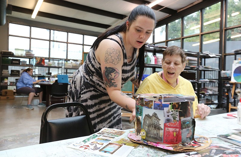 NWA Democrat-Gazette/DAVID GOTTSCHALK Brandi Tyner, lead art teacher at Life Styles Blair Center, helps Friday, August 23, 2019, Maureen Connelly with the decoration of her hat for use at the Polo in the Ozarks 2019 on October 5th. The center is working on creating fine art pieces for it's last art show of the year and hats for the polo event that benefits the center. Life Styles Inc.,  is a nonprofit founded in Fayetteville in 1976 as an alternative to institutional placement for adults with disabilities.