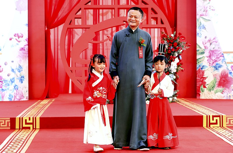 FILE - In this file photo taken Friday, May 10, 2019, Jack Ma, then chairman of Alibaba Group, poses for photos during a ceremony where he acted as the chief witness of the wedding of 102 couples of Alibaba employees in Hangzhou in eastern China's Zhejiang province. Ma hasn't been seen since he angered regulators with an October 2020 speech. That is prompting speculation about what might happen to the billionaire founder of the world's biggest e-commerce company. (Chinatopix Via AP, File)