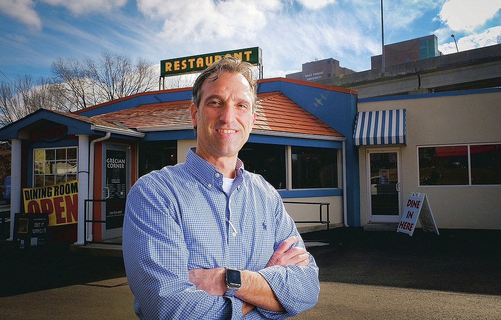 Angelo Ballas, owner of the Grecian Corner, stands for a portrait in front of his restaurant Tuesday, Dec. 15, 2020 in Winston-Salem, N.C., which is celebrating its 50th anniversary. (Andrew Dye/The Winston-Salem Journal via AP)