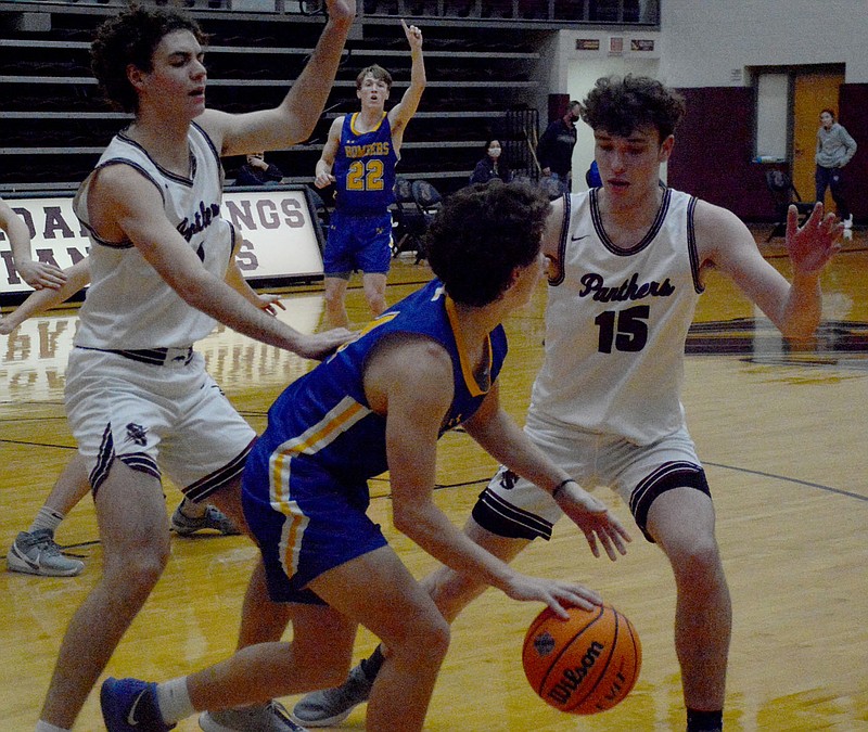 Graham Thomas/Siloam Sunday
Siloam Springs senior Max Perkins, left, and sophomore Dalton Newman trap a Mountain Home player in front of the Siloam Springs bench during the second half Friday at Panther Activity Center. Mountain Home defeated the Panthers 53-47.