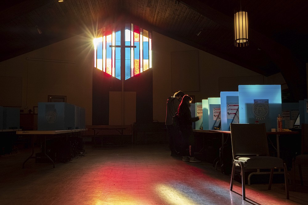 Voters mark their ballots at the Lawrenceville Road United Methodist Church in Tucker, Ga. during the Senate runoff election Tuesday morning, Jan. 5, 2021. (AP Photo/Ben Gray)
