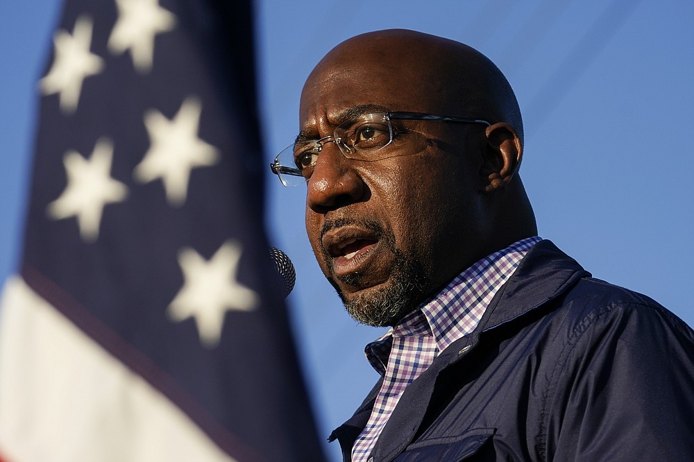 FILE - In this Nov. 15, 2020, file photo Raphael Warnock, a Democratic candidate for the U.S. Senate, speaks during a campaign rally in Marietta, Ga. As the head of the Atlanta church where Martin Luther King Jr. preached, Warnock has not shied away from impassioned sermons and forceful advocacy on behalf of the poor and disadvantaged. The 51-year-old now wants to take that progressive platform to the U.S. Senate. He is running to unseat one of Georgia's Republican senators, Kelly Loeffler, in the Jan. 5 race. (AP Photo/Brynn Anderson, File)