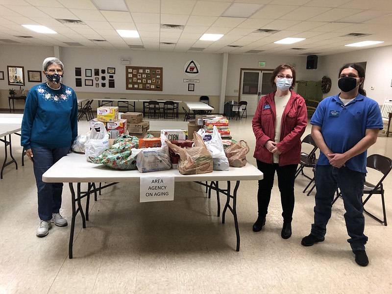 Reita Currie with Garland County Extension Homemakers recently presented around $375 worth of nonperishables to Area Agency on Aging, represented by Karen Chase, case management supervisor, and Jared Jones, case manager. - Submitted photo story.lead_photo.caption