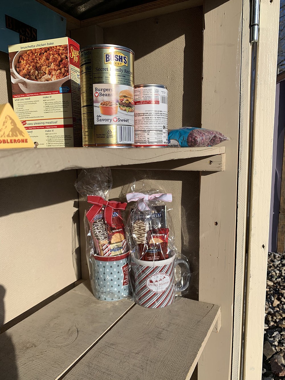 SALLY CARROLL/SPECIAL TO WEEKLY VISTA The shelves of a free little food pantry box are almost bare after the holidays. The food pantry box, located at 100 Cooper Road in Bella Vista, is an undertaking that relies on people to donate non-perishables to help out fellow neighbors. The box is located in the United Lutheran Church's parking lot.