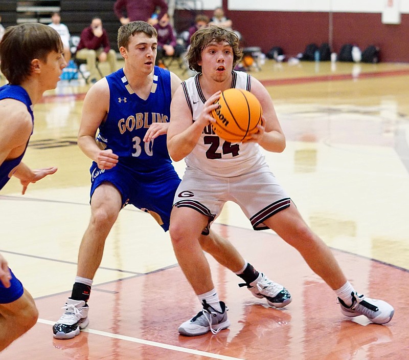 Westside Eagle Observer/RANDY MOLL Gentry's Andrew Godfrey looks to pass off the ball to a teammate during the Gentry-Harrison game on Jan. 5. story.lead_photo.caption