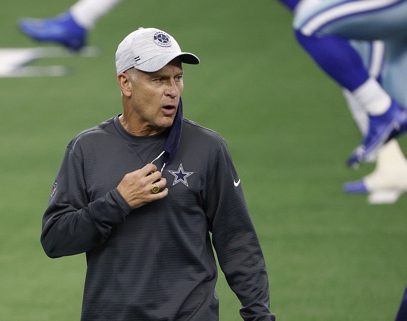 FILE - In this Oct. 11, 2020, file photo, Dallas Cowboys defensive coordinator Mike Nolan talks to players as they warm up for an NFL football game against the New York Giants in Arlington, Texas. The Cowboys have fired Nolan after their defense allowed a franchise record in points and finished 31st in the NFL against the run in his only season, the team announced Friday, Jan. 8, 2021. (AP Photo/Ron Jenkins, File)