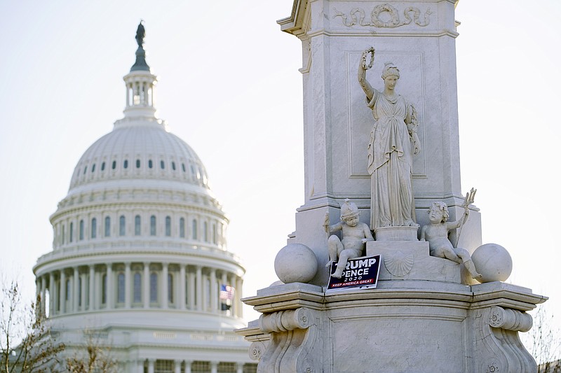 The Capitol stands mostly quiet, Thursday morning, Jan. 7, 2021 in Washington. The House and Senate certified the Democrat's electoral college win early Thursday after a violent throng of pro-Trump rioters spent hours Wednesday running rampant through the Capitol. A woman was fatally shot, windows were bashed and the mob forced shaken lawmakers and aides to flee the building, shielded by Capitol Police. (AP Photo/Matt Slocum)