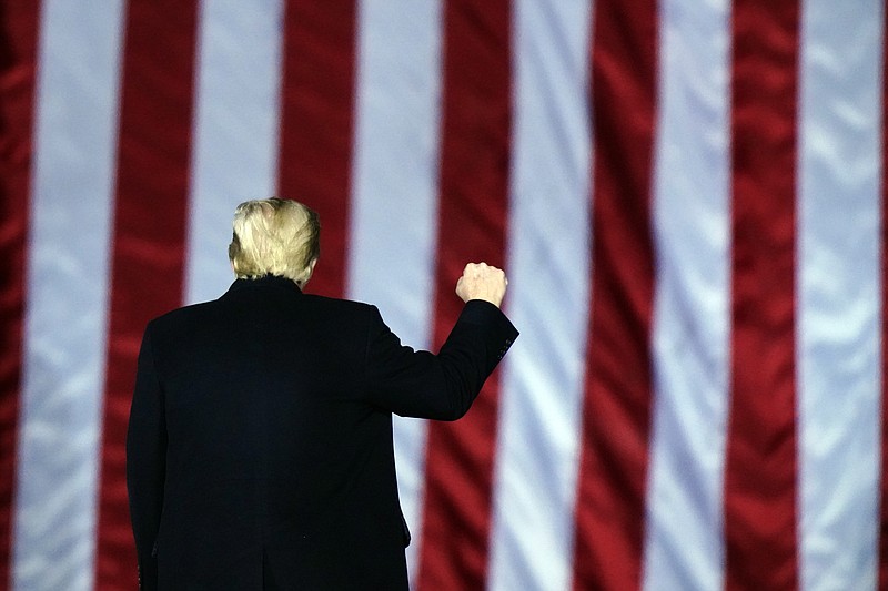 President Donald Trump gestures at a campaign rally in support of U.S. Senate candidates Sen. Kelly Loeffler, R-Ga., and David Perdue in Dalton, Ga., Monday, Jan. 4, 2021. (AP Photo/Brynn Anderson)