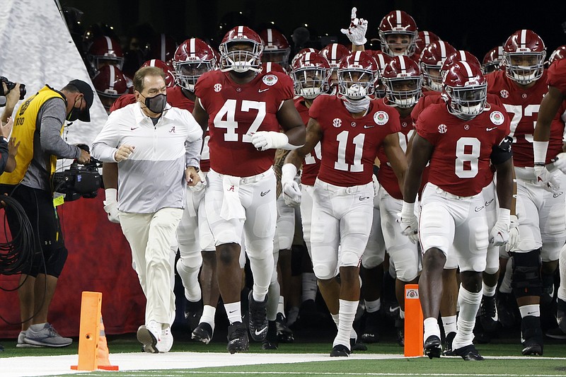Alabama head coach Nick Saban, front left, jogs onto the field with his team for their Rose Bowl NCAA college football game against Notre Dame in Arlington, Texas, Friday, Jan. 1, 2021. (AP Photo/Ron Jenkins)