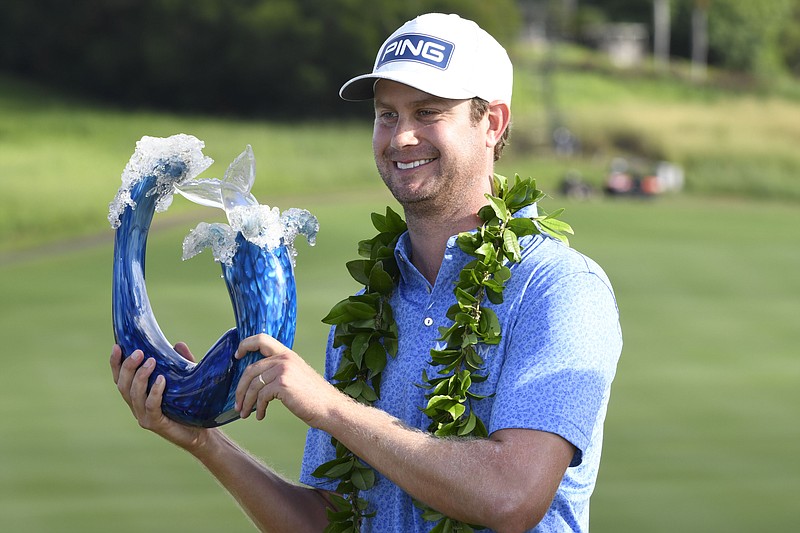 Harris English holds the champions trophy after the final round of the Tournament of Champions golf event, Sunday, Jan. 10, 2021, at Kapalua Plantation Course in Kapalua, Hawaii. (Matthew Thayer/The Maui News via AP)