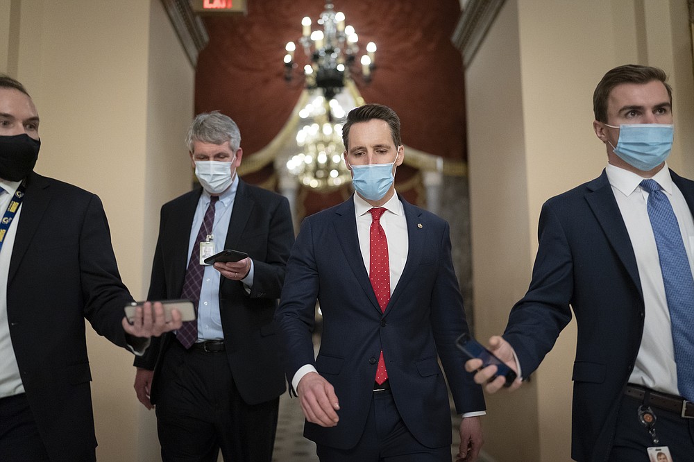 After violent protesters loyal to President Donald Trump stormed the U.S. Capitol today, Sen. Josh Hawley, R-Mo., walks to the House chamber to challenge the results of the presidential election in Pennsylvania during the joint session of the House and Senate to count the Electoral College votes cast in November's election, at the Capitol in Washington, Wednesday, Jan. 6, 2021. (AP Photo/J. Scott Applewhite)