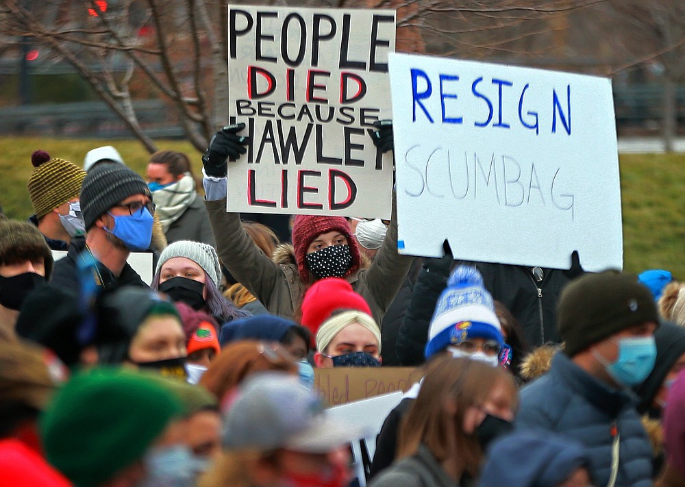 About 300 demonstrators gather after painting a sign in the middle of Broadway Saturday, Jan. 9, 2021 outside the historic Old Courthouse in downtown St. Louis. Speakers called for Sen. Josh Hawley, R-Mo., to resign following a seizure and occupation of the U.S. Capitol in Washington. (Christian Gooden/St. Louis Post-Dispatch via AP)