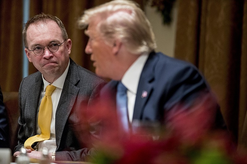 FILE - In this Thursday, Dec. 5, 2019, file photo, then-acting chief of staff Mick Mulvaney, left, listens to President Donald Trump, right, speak at a luncheon with members of the United Nations Security Council in the Cabinet Room at the White House in Washington. Republicans are coming to grips with the fallout of Trump's false attacks on the election, which fueled the anger of supporters who stormed the U.S. Capitol on Jan. 6, 2021. Mulvaney says he never thought people would take the president's words so literally. (AP Photo/Andrew Harnik, File) story.lead_photo.caption
