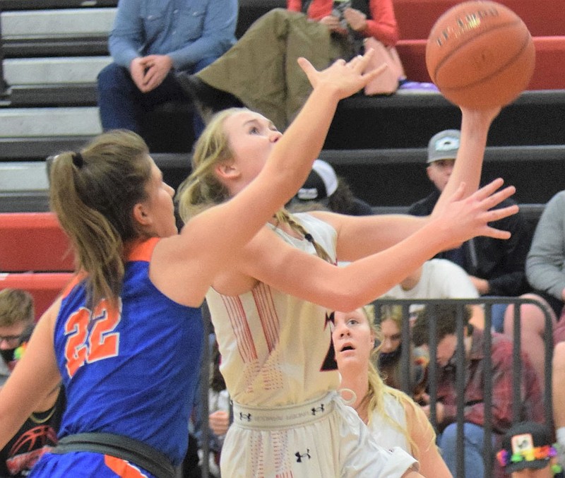 RICK PECK/SPECIAL TO MCDONALD COUNTY PRESS McDonald County's Kristin Penn gets fouled while attempting a layup during the Lady Mustangs' 70-31 win over Springfield Hillcrest on Jan. 4 at MCHS.