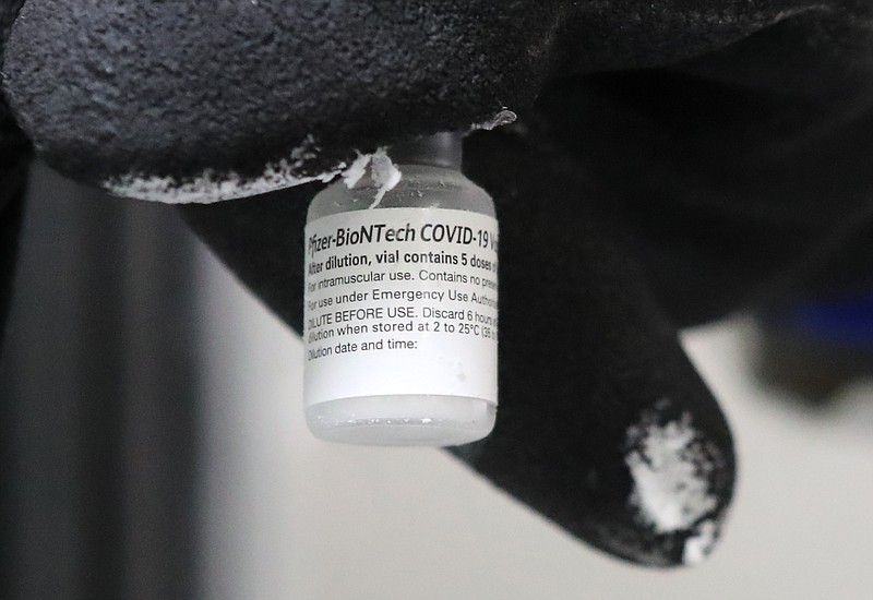 Health Mart Pharmacist Kristen Shamlin displays a vial of COVID-19 vaccine Monday, Jan. 11. - Photo by Richard Rasmussen of The Sentinel-Record