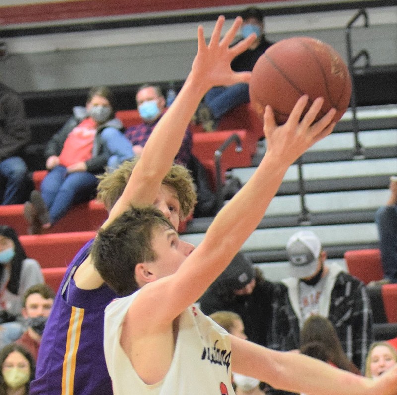 RICK PECK/SPECIAL TO MCDONALD COUNTY PRESS McDonald County's Pierce Harmon scores despite the defense of Monett's Ben Hoyt. Harmon finished with 24 points to lead the Mustangs in their 66-53 loss to the Cubs on Jan. 8 at MCHS.
