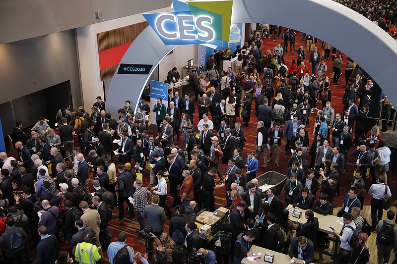 FILE - In this Jan. 7, 2020 file photo, crowds enter the convention center on the first day of the CES tech show,  in Las Vegas. Every January, huge crowds descend on Las Vegas for the CES gadget show, an extravaganza of tech and glitz intended to set the tone for the coming year in consumer technology. CES kicks off this week, but thanks to the pandemic, it will be in a radical new format — a “virtual” show taking place only in cyberspace. (AP Photo/John Locher, File)