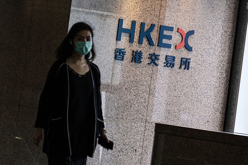 A person past signage for Hong Kong Exchanges & Clearing at the Exchange Square complex in Hong Kong on Aug. 19, 2020. MUST CREDIT: Bloomberg photo by Roy Liu.