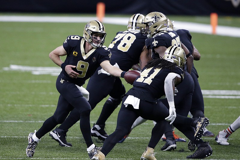 New Orleans Saints quarterback Drew Brees (9) hands off to running back Alvin Kamara (41) in the first half of Sunday's wild-card playoff game against the Chicago Bears in New Orleans. - Photo by Butch Dill of The Associated Press story.lead_photo.caption