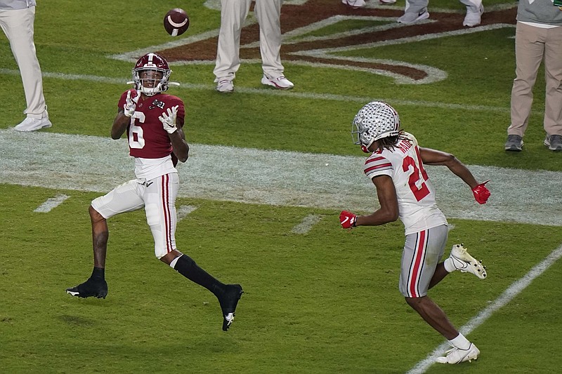 Alabama wide receiver DeVonta Smith catches a touchdown pass in front of Ohio State cornerback Shaun Wade during the first half of an NCAA College Football Playoff national championship game, Monday, Jan. 11, 2021, in Miami Gardens, Fla. (AP Photo/Wilfredo Lee) story.lead_photo.caption