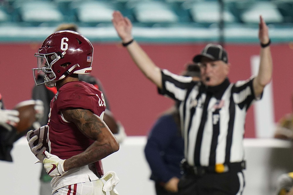 Alabama wide receiver DeVonta Smith scores a touchdown against Ohio State during the first half of an NCAA College Football Playoff national championship game, Monday, Jan. 11, 2021, in Miami Gardens, Fla. (AP Photo/Chris O'Meara)