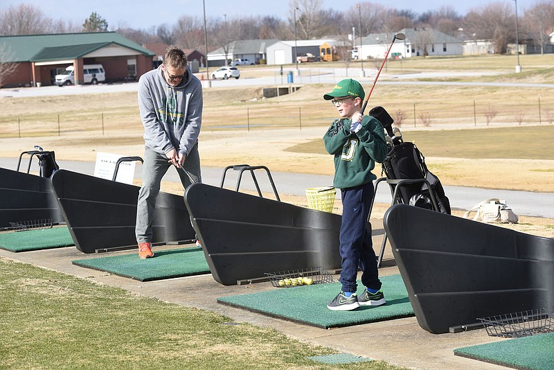 HONING THEIR GAME
Matt Emmons of Siloam Springs and his son, Will Emmons, 10, practice their golf game on Saturday Jan. 9 2021 at The First Tee Northwest Arkansas in Lowell. First Tee has indoor and outdoor golf practice facilities. Go to nwaonline.com/210110Daily/ to see more photos.
(NWA Democrat-Gazette/Flip Putthoff)