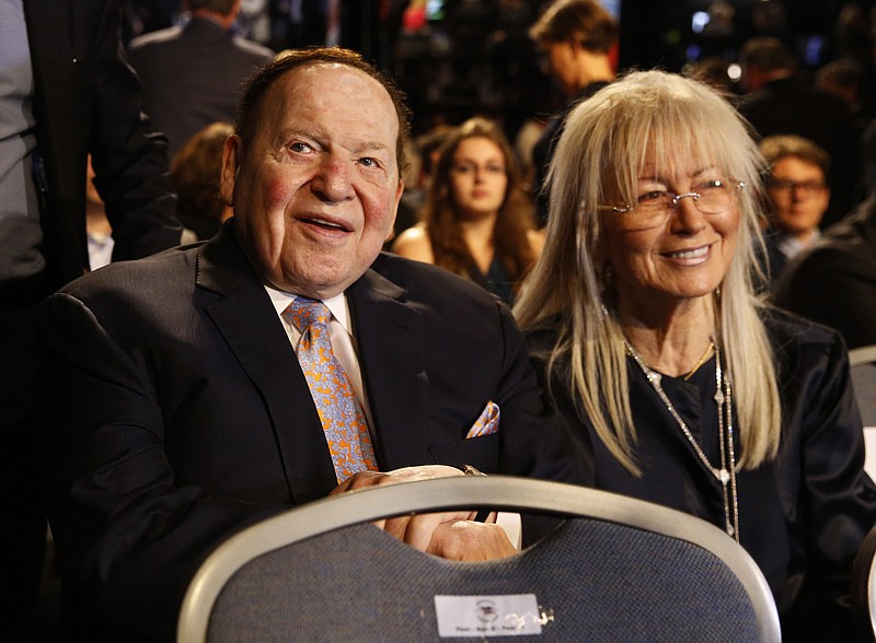 FILE - In this Sept. 26, 2016 file photo, Chief Executive of Las Vegas Sands Corporation Sheldon Adelson sits with his wife Miriam waits for the presidential debate between Democratic presidential nominee Hillary Clinton and Republican presidential nominee Donald Trump at Hofstra University in Hempstead, N.Y.  Adelson, the billionaire mogul and power broker who built a casino empire spanning from Las Vegas to China and became a singular force in domestic and international politics has died after a long illness, his wife said Tuesday, Jan. 12, 2021.(AP Photo/Patrick Semansky, File)