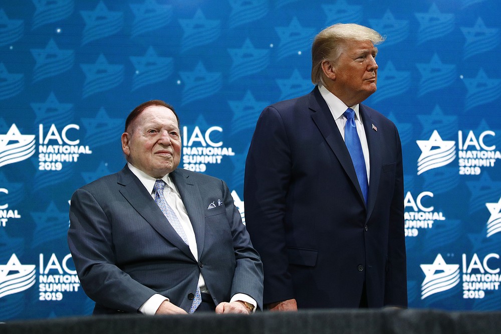 FILE - In this Dec. 7, 2019 file photo, President Donald Trump stands alongside Las Vegas Sands Corporation Chief Executive and Republican mega donor Sheldon Adelson before speaking at the Israeli American Council National Summit in Hollywood, Fla. Adelson, the billionaire mogul and power broker who built a casino empire spanning from Las Vegas to China and became a singular force in domestic and international politics has died after a long illness, his wife said Tuesday, Jan. 12, 2021. (AP Photo/Patrick Semansky, File)