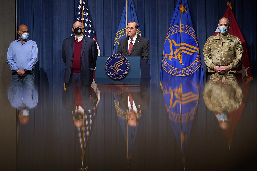 The Associated Press
Health and Human Services Secretary Alex Azar, center, speaks during a news conference on Operation Warp Speed and COVID-19 vaccine distribution Tuesday in Washington. Standing alongside Azar from left are Dr. Moncef Slaoui, chief science adviser to Operation Warp Speed, Dr. Robert Redfield, director of the Centers for Disease Control and Prevention, and U.S. Army Gen. Gustave Perna, chief operating officer of Operation Warp Speed.