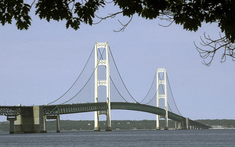 FILE - This July 19, 2002, file photo, shows the Mackinac Bridge that spans the Straits of Mackinac from Mackinaw City, Mich. Supporters and opponents of a proposed oil pipeline tunnel beneath the Great Lakes channel are making their case to federal officials. The Army Corps of Engineers hosted an online public hearing Monday, Jan. 11, 2021, on Enbridge's application for a permit. The Canadian pipeline company wants to drill a nearly 4-mile (6.4-kilometer) tunnel through bedrock under the Straits of Mackinac that would house a replacement for twin pipes that have run along the bottom of the waterway connecting Lake Huron and Lake Michigan for 67 years.(AP Photo/Carlos Osorio, File)