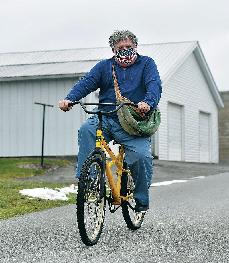 Hanging up his bag after delivering newspapers for 50 years
