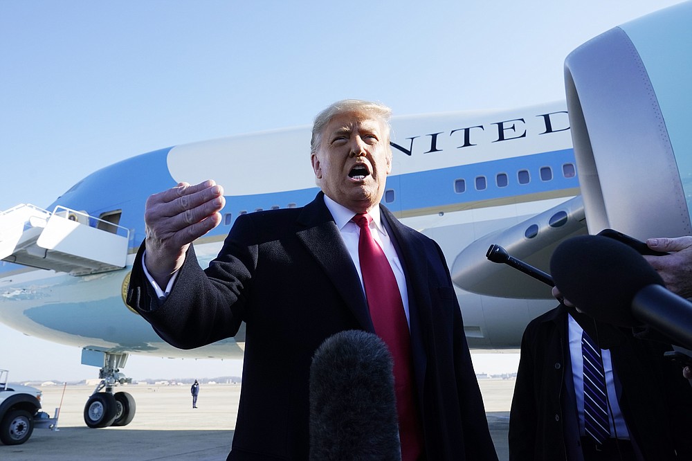 President Donald Trump speaks to the media before boarding Air Force One, at Andrews Air Force Base, Md. (AP Photo/Alex Brandon)