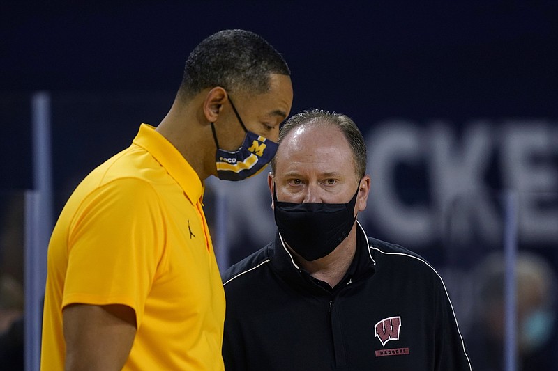 Wisconsin coach Greg Gard, right, talks to Michigan coach Juwan Howard after Tuesday's game in Ann Arbor, Mich. - Photo by Carlos Osorio of The Associated Press story.lead_photo.caption