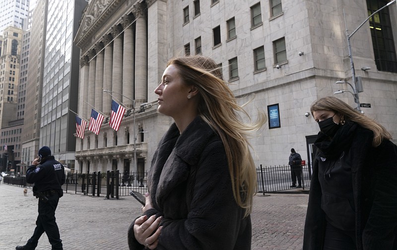 People walk by the New York Stock Exchange, Wednesday, Jan. 13, 2021. Markets around the world have rushed higher recently on building optimism that a healthier economy is on the way because of the rollout of coronavirus vaccines and the prospect for more stimulus from a U.S. government soon to be run by Democrats. (AP Photo/Mark Lennihan)