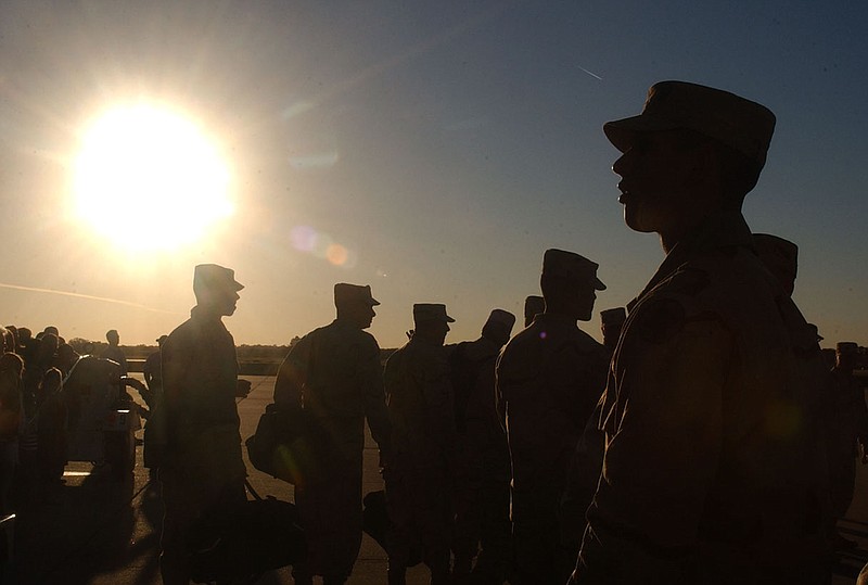 142nd Field Artillery Brigade soldiers wait to load a plane Nov. 6, 2005 in Highfill. (Arkansas Democrat-Gazette File Photo)