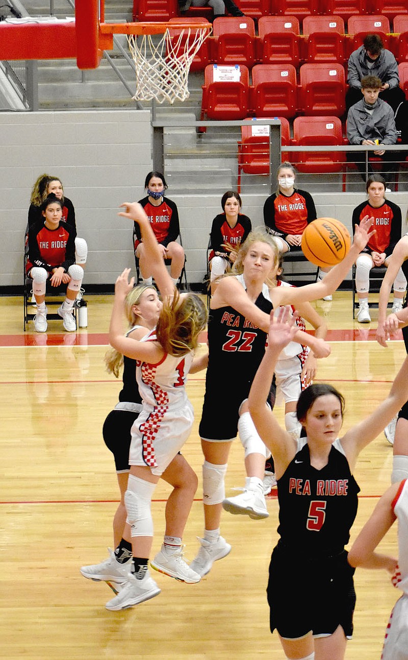 MARK HUMPHREY  ENTERPRISE-LEADER/Pea Ridge's Blakelee Winn blocks a shot by Farmington's Mazzie Carlson during a down-to-the-wire 4A-1 Conference girls basketball contest won by the Lady Blackhawks, 58-57, on Tuesday, Jan. 12 at Cardinal Arena.