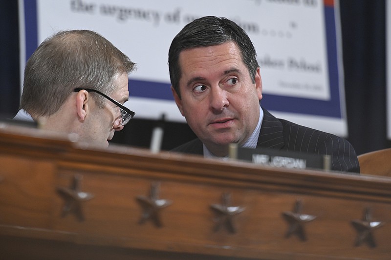 Reps. Jim Jordan, R-Ohio, left, and Devin Nunes, R-Calif., confer during a confirmation hearing in 2019. MUST CREDIT: Washington Post photo by Jahi Chikwendiu