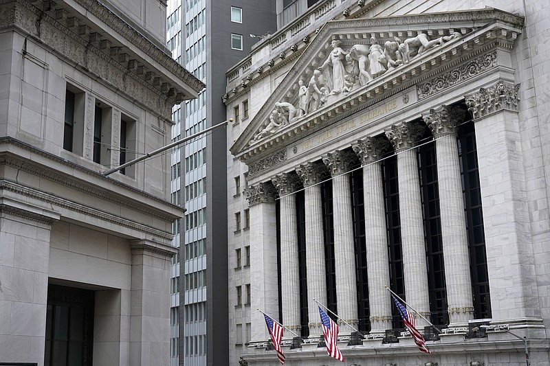 FILE - This Monday, Nov. 23, 2020 file photo shows the New York Stock Exchange, right, in New York.  U.S. stocks are ticking higher Thursday, Jan. 14, 2021, despite a dismal report on the number of layoffs sweeping the country.  (AP Photo/Seth Wenig)