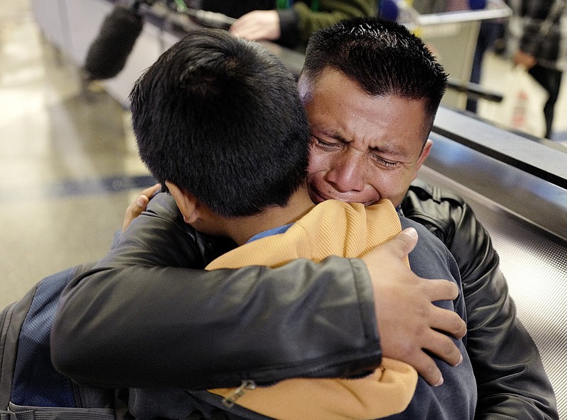 In this Jan. 22, 2020, file photo, David Xol-Cholom, of Guatemala, hugs his son Byron at Los Angeles International Airport as they reunite after being separated during the Trump administration's wide-scale separation of immigrant families, in Los Angeles. - AP Photo/Ringo H.W. Chiu, File