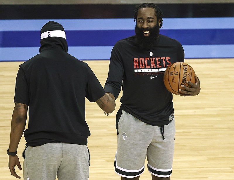 Houston Rockets guard James Harden, right, talks with Los Angeles Lakers forward Markieff Morris before Tuesday's NBA game in Houston. - Photo by Troy Taormina/Pool Photo via The Associated Press