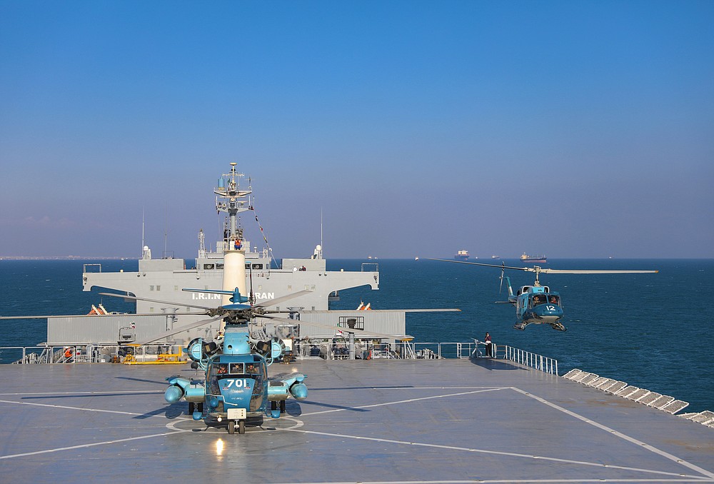 This image released Thursday, Jan. 14, 2021, by the Iranian Army shows helicopters and the Iranian-made Makran logistics vessel during a naval drill. Iran fired cruise missiles Thursday as part of the drill in the Gulf of Oman, state media reported, amid heightened tensions with the U.S. (Iranian Army via AP)