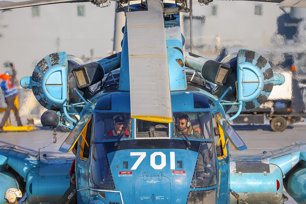 This image released Thursday, Jan. 14, 2021, by the Iranian Army shows a helicopter on an Iranian-made Makran logistics vessel during a naval drill. Iran fired cruise missiles Thursday as part of the drill in the Gulf of Oman, state media reported, amid heightened tensions with the U.S. (Iranian Army via AP)