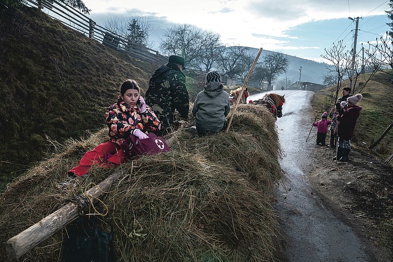 Dr. Viktoria Mahnych rides an old-fashioned horse-driven cart to visit a patient with COVID-19 in Verhovyna village, Ivano-Frankivsk region of Western Ukraine, Wednesday, Jan. 6, 2021. Ukraine is struggling to contain the coronavirus pandemic that has inundated its overburdened medical system, as Dr. Viktoria Mahnych goes door to door providing much needed help to patients.(AP Photo/Evgeniy Maloletka)