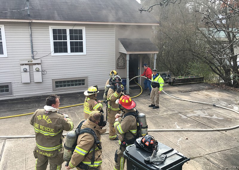 Members of the 70 West Fire Department and Piney Fire Department work to extinguish a fire in Unit A of a duplex at 400 Majestic Lodge Road on Friday. - Photo by Richard Rasmussen of The Sentinel-Record