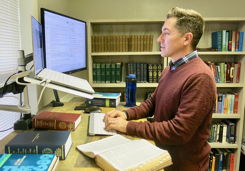 Westside Eagle Observer/SUSAN HOLLAND
Chris Whorton, pastor of the Heritage Baptist Church in Gravette, works on the computer in his office Friday afternoon, Jan. 15. Whorton says he spends quite a bit of time on the computer, researching and preparing sermons for the congregation he has pastored since November of 2020.