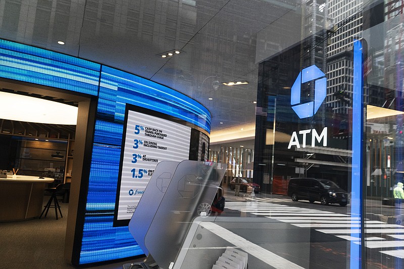 A Chase ATM is open, Wednesday, Jan. 13, 2021 in New York.  JPMorgan Chase & Co., the nation’s largest bank by assets, said its fourth quarter profits jumped by 42% from a year earlier, as the firm’s investment bank division had a stellar quarter and the bank’s balance sheet improved despite the pandemic.  (AP Photo/Mark Lennihan)