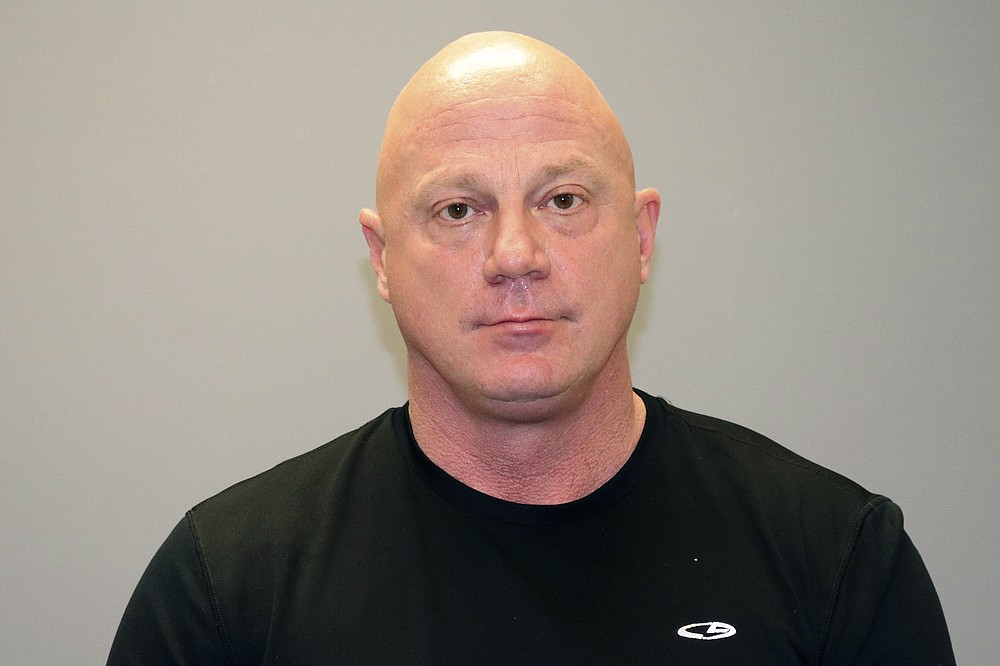 This undated photo provided by the Grapevine, Texas Police Department in January 2021 shows Larry Rendall Brock Jr. During the deadly riot at the U.S. Capitol on Wednesday, Jan. 6, 2021, Brock was photographed on the Senate floor wearing a helmet and heavy vest and carrying zip-tie handcuffs. The retired Air Force officer was arrested in Texas and charged Sunday, Jan. 10 in federal court in the District of Columbia. (Grapevine, Texas Police Department via AP)