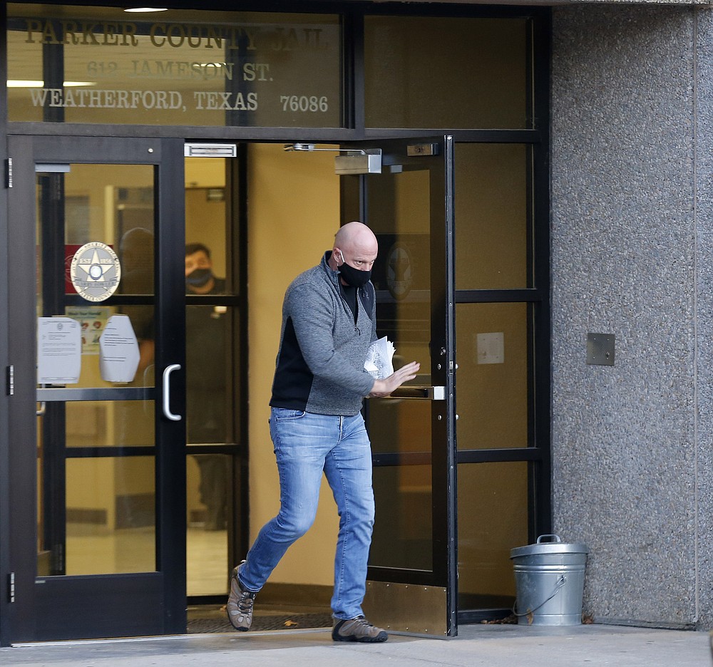Retired Air Force officer Larry Rendall Brock Jr. walks out of Parker County Jail upon release on Thursday, Jan. 14, 2021 in Weatherford, Texas. Brock was released from custody on Thursday following a detention hearing in federal court. Brock was identified in photos as part of the mob that stormed the U.S. Capitol last week. (Vernon Bryant/The Dallas Morning News via AP)